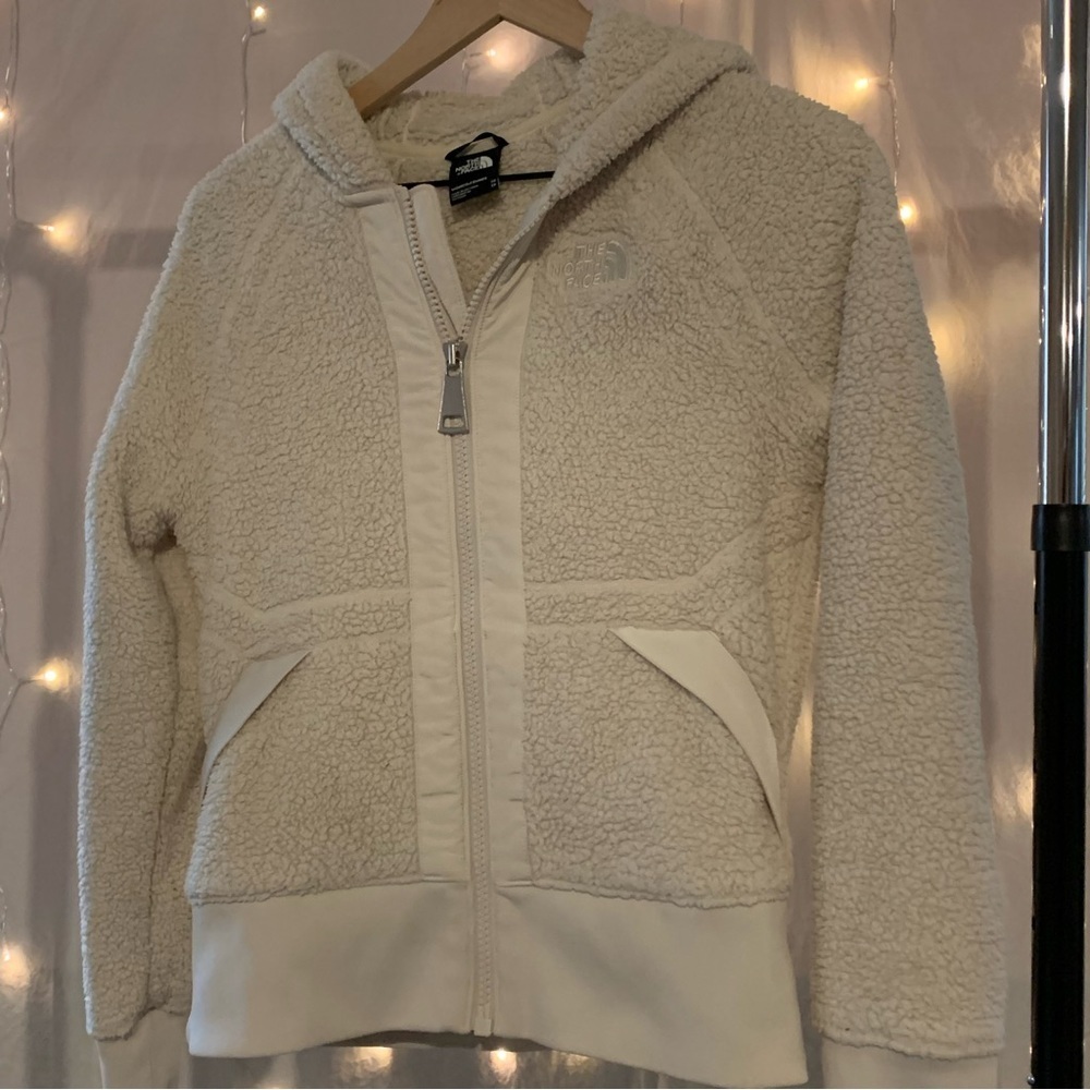 The north face fuzzy xs but fits like a small, Sherpa type jacket. like new.